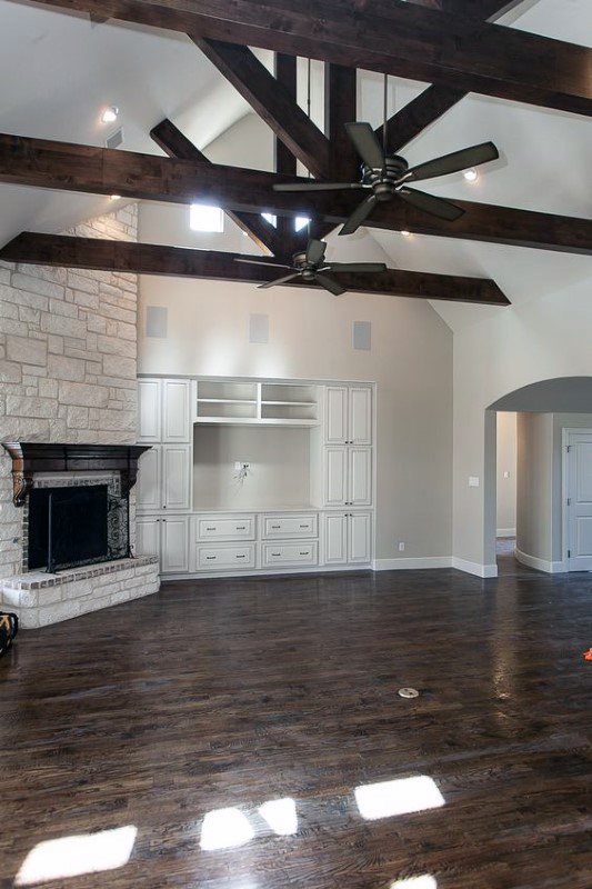 Living room stone corner fireplace design