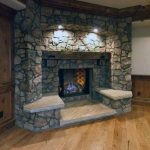 Rustic Stone Corner Fireplace Design With Hardwood Flooring