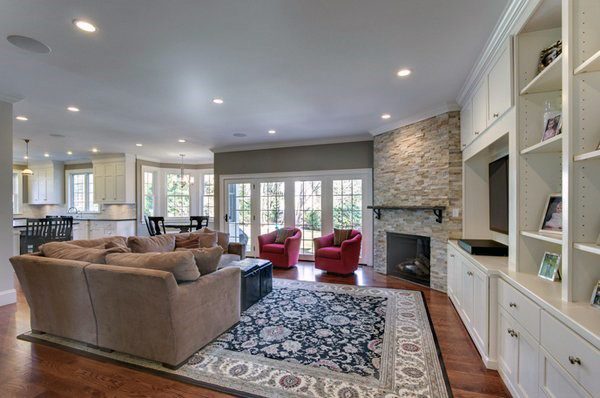 Stone with white bookcases in living room corner fireplace design